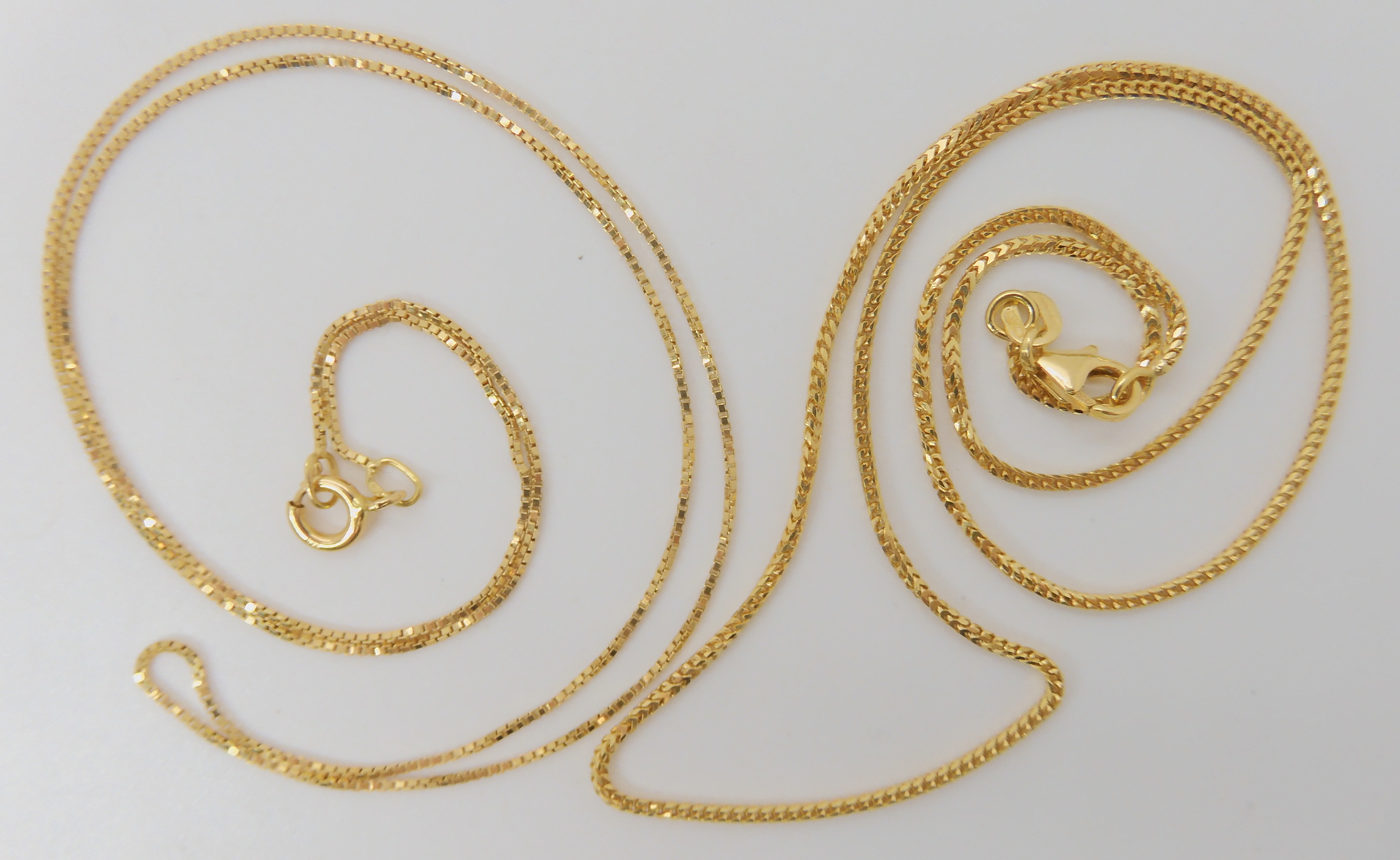 An 18ct gold box chain, length 46cm, together with a fancy 18ct herringbone chain length 40cm,