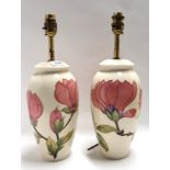 A pair of Moorcroft pink magnolia table lamps, 38cm high Condition Report: one is crazed.