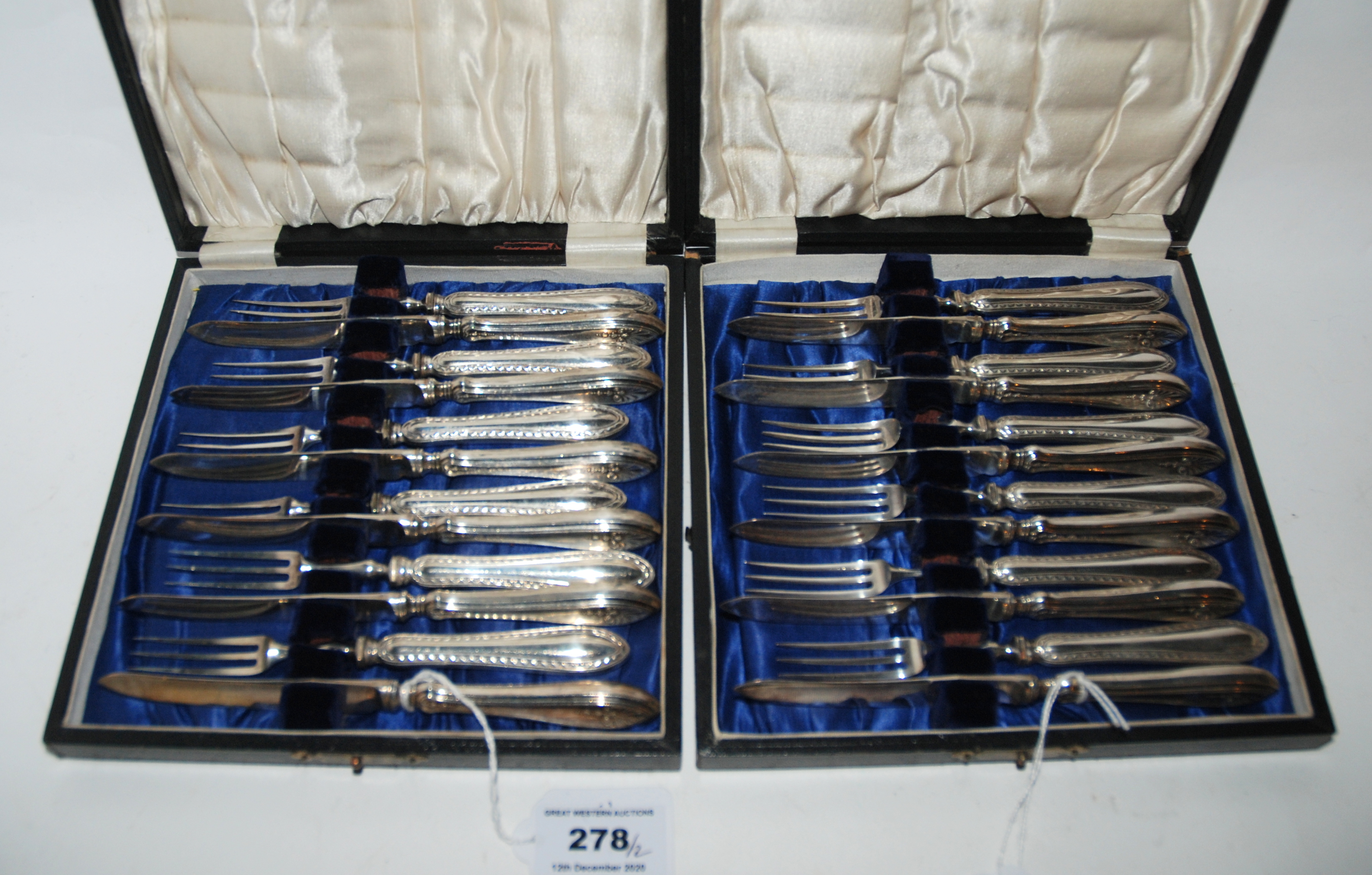 A lot comprising two cased twelve piece sets of silver handled dessert knives and forks, Sheffield