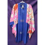 A rose embroidered piano shawl, a cobalt blue and pink kimono, a embroidered green jacket and a