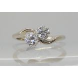 A white metal twin stone diamond ring, the combined diamond weight is estimated approx at 0.40cts,