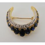 A bright yellow metal sapphire and diamond crescent moon brooch, diameter 2.8cm, weight 10.8gms