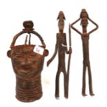 A pair of iron tribal figures and a metal tribal head Condition Report: Available upon request