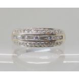 An 18ct white gold diamond dress ring, set with estimated approx 0.50cts of brilliant and baguette