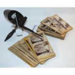 A vintage stereoscope viewer and collection of cards Condition Report: Available upon request