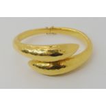 A bright yellow metal bangle stamped K22, weight 37.6gms Condition Report: Available upon request