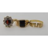 A 9ct gold garnet and clear gem set cluster ring size N1/2, a 9ct onyx signet ring N1/2 and a 9ct