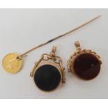 Two 9ct gold double sided agate fob seals, and a stick pin with an attached 1853 1 dollar USA