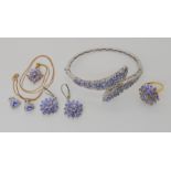 A collection of silver and tanzanite jewellery to include a bangle, ring, two pairs of earrings