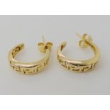 A pair of bright yellow metal Greek key pattern creole earrings, butterflies stamped 585, weight 3.