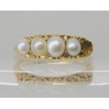 An 18ct gold pearl and diamond accent ring with scrolled setting size N1/2 one pearl missing, size