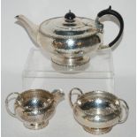 A hammered silver three piece tea service, Sheffield 1925, 936gms Condition Report: Available upon