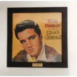 A lot of Elvis Presley vinyl LP records with wall hanging frames from his movies with Burning