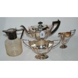 A lot comprising a three piece EPNS tea service and a silver plate mounted cut glass claret jug