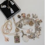 An extensive silver charm bracelet together with other silver and white metal items Condition
