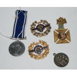 A lot comprising a Police medal, two woman's British Legion badges, a Victoria commemorative cross