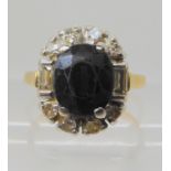 An 18ct gold sapphire and diamond cluster ring, set with estimated approx 0.25cts of brilliant and