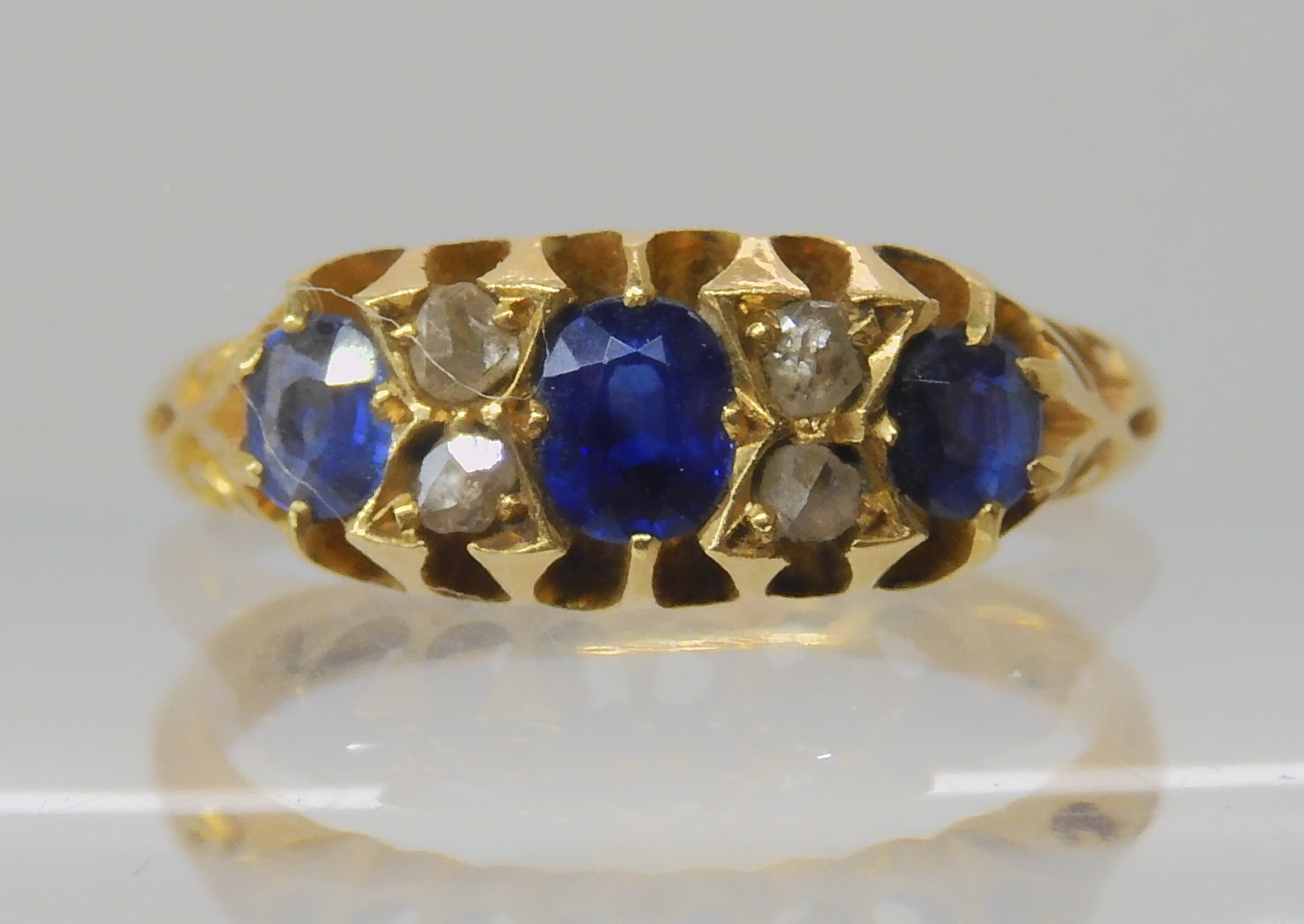 An 18ct gold sapphire and rose cut diamond ring , size J, weight 2.8gms Condition Report: