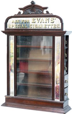 Advertising cigarette display cabinet ASK FOR EVANS SPECIAL CIGARETTES. An ornate wooden, glazed and