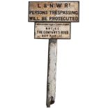 A pair of London & North Western Railway cast iron signs. L&NWRy PERSONS TRESPASSING WILL BE