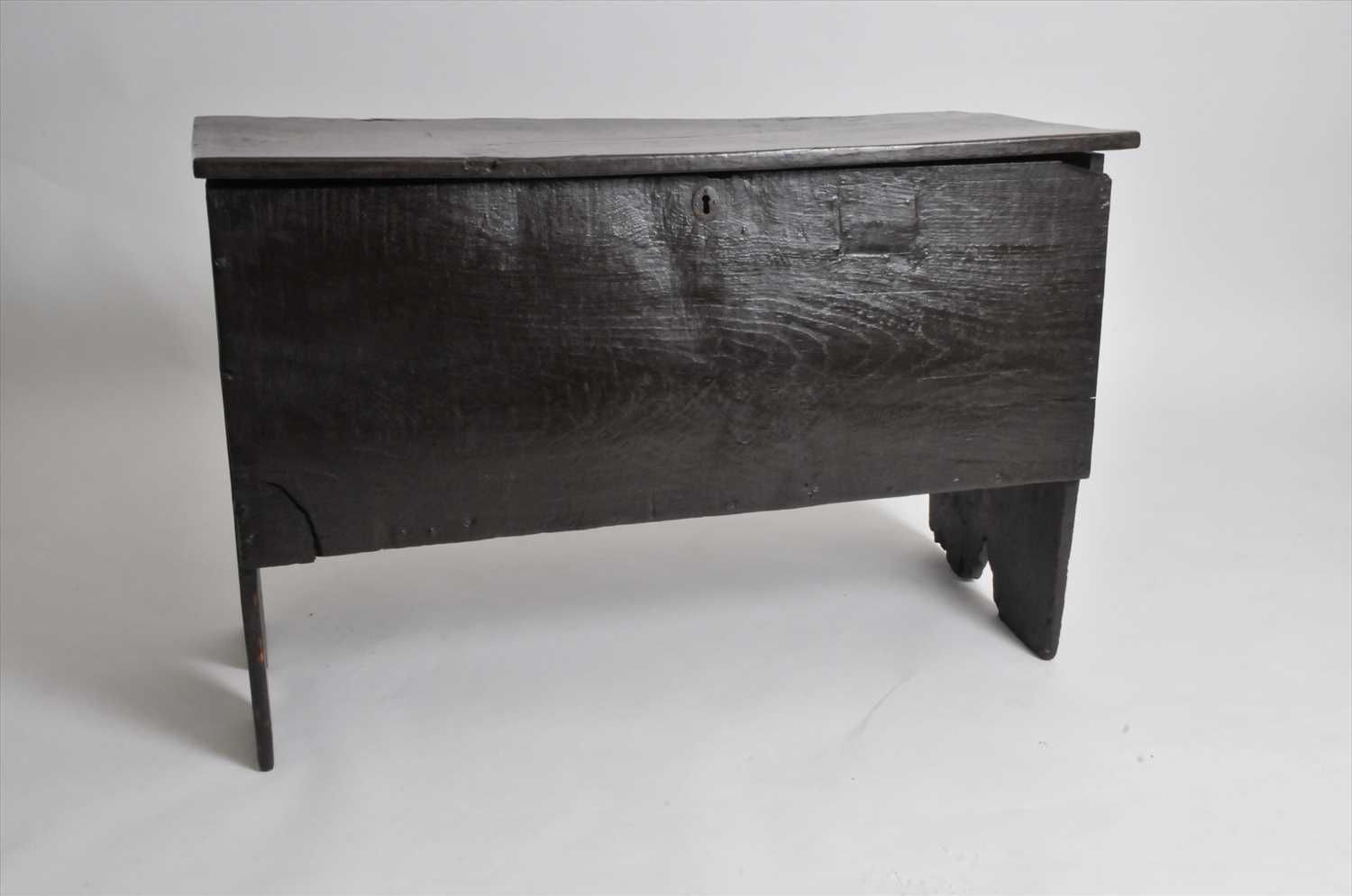 A rustic 17th century or later six plank country oak coffer