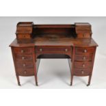 An Edwardian Maple & Co leather-topped inlaid mahogany desk