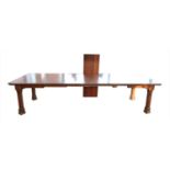 A large Victorian mahogany and walnut extending dining table, with a bevelled border and canted