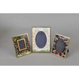 A Halcyon Days enamelled photograph frame, decorated with roses on a white ground, 14.5cm x 10.