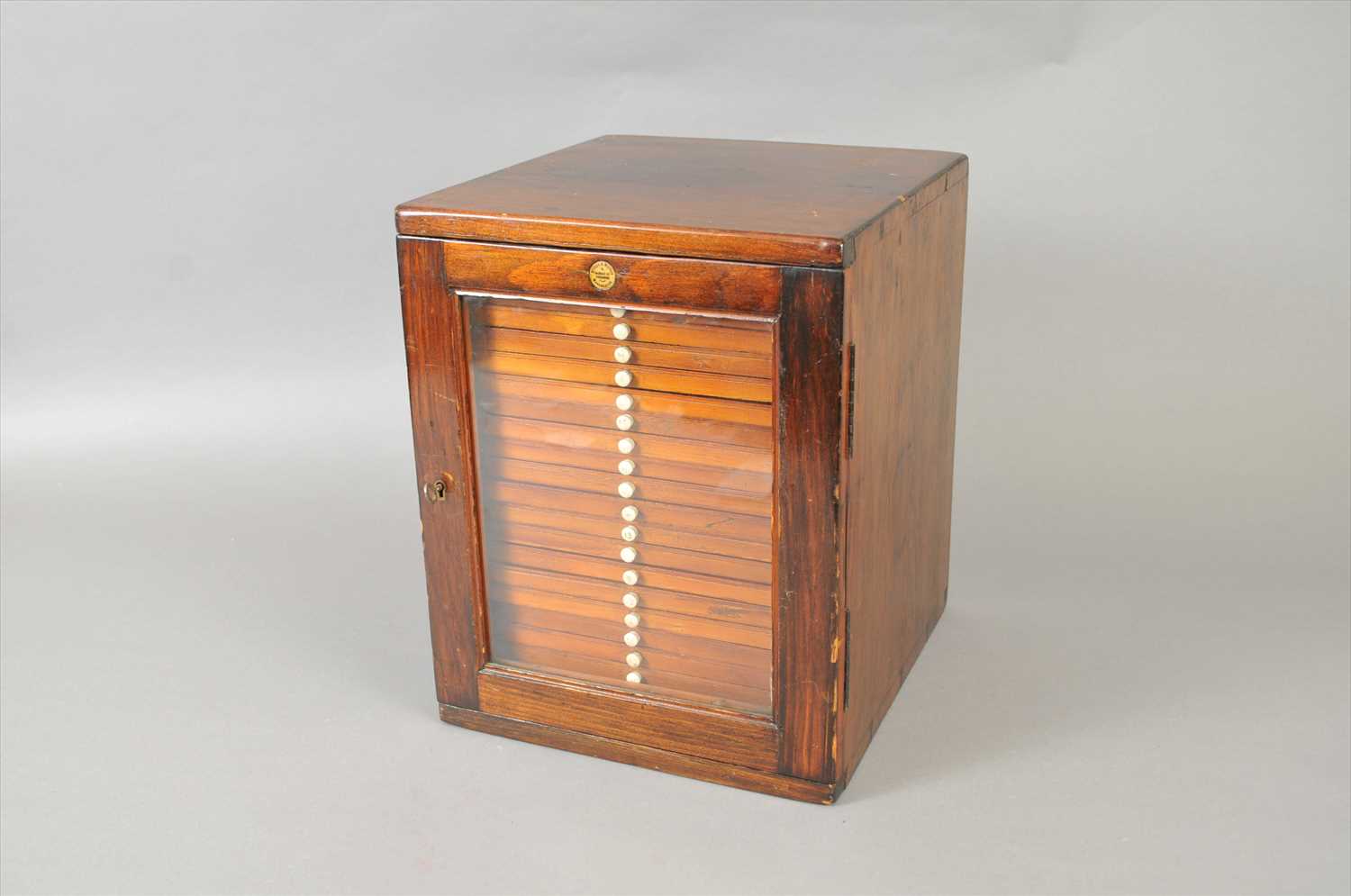 An early 20th century mahogany coin collector's cabinet, 'Stokes & Watson, Manchester'