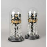 A pair of Victorian glass table lustres under domes
