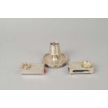 Two silver match box holders and a silver mounted candlestick