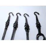 A four piece wrought iron fireside companion set