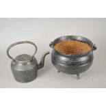 A cast iron cauldron, a kettle and hat box