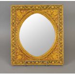 A Qajar lacquered and gilded papier mache framed wall mirror