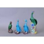 A group of brightly coloured Chinese earthenware birds