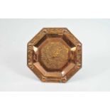 An octagonal copper charger in the Arts and crafts style, in the manner of the Newlyn School