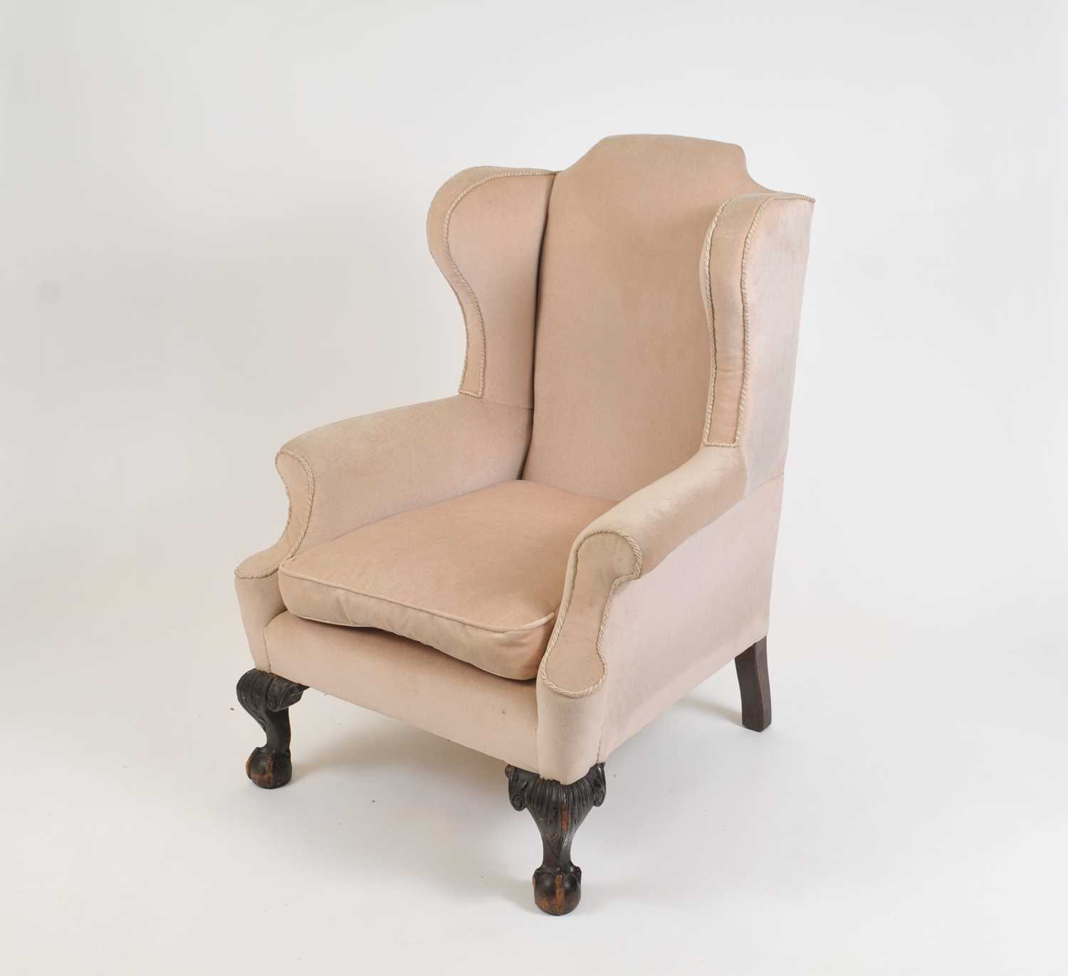 A large and heavy Queen Ann style upholstered wing-back arm chair