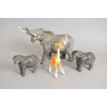 Three Beswick elephants and a giraffe