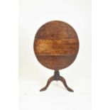 A 19th century oak tilt-top table