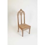 A decorative limed oak high back chair in the Gothic style