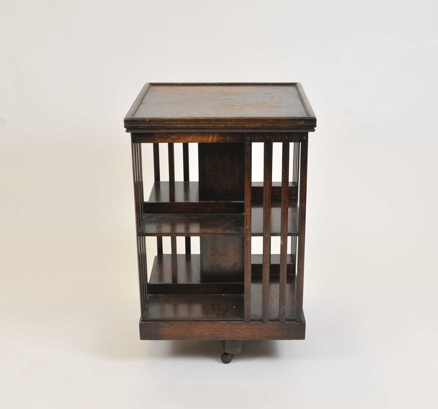 A large early 20th century stained oak revolving bookcase