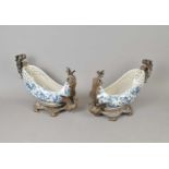 A decorative pair cast of metal mounted blue and white ceramic boats