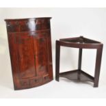 A large Victorian bow-fronted mahogany corner cupboard on stand