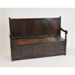 A large 19th century panelled country oak settle,