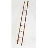 An early 20th century folding oak library ladder