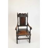 A heavy carved oak arm chair in the Carolean style