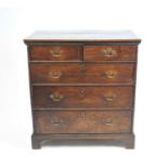 A 19th century country oak chest of two short and three long graduated drawers