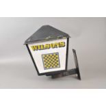 A weathered 20th century outdoor porch / beer garden lamp advertising Wilson's Brewery