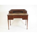 A reproduction mahogany writing desk in the manner of Maple & Co