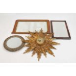An early 20th century Garrard carved gilt wood starburst framed wall clock and three wall mirrors